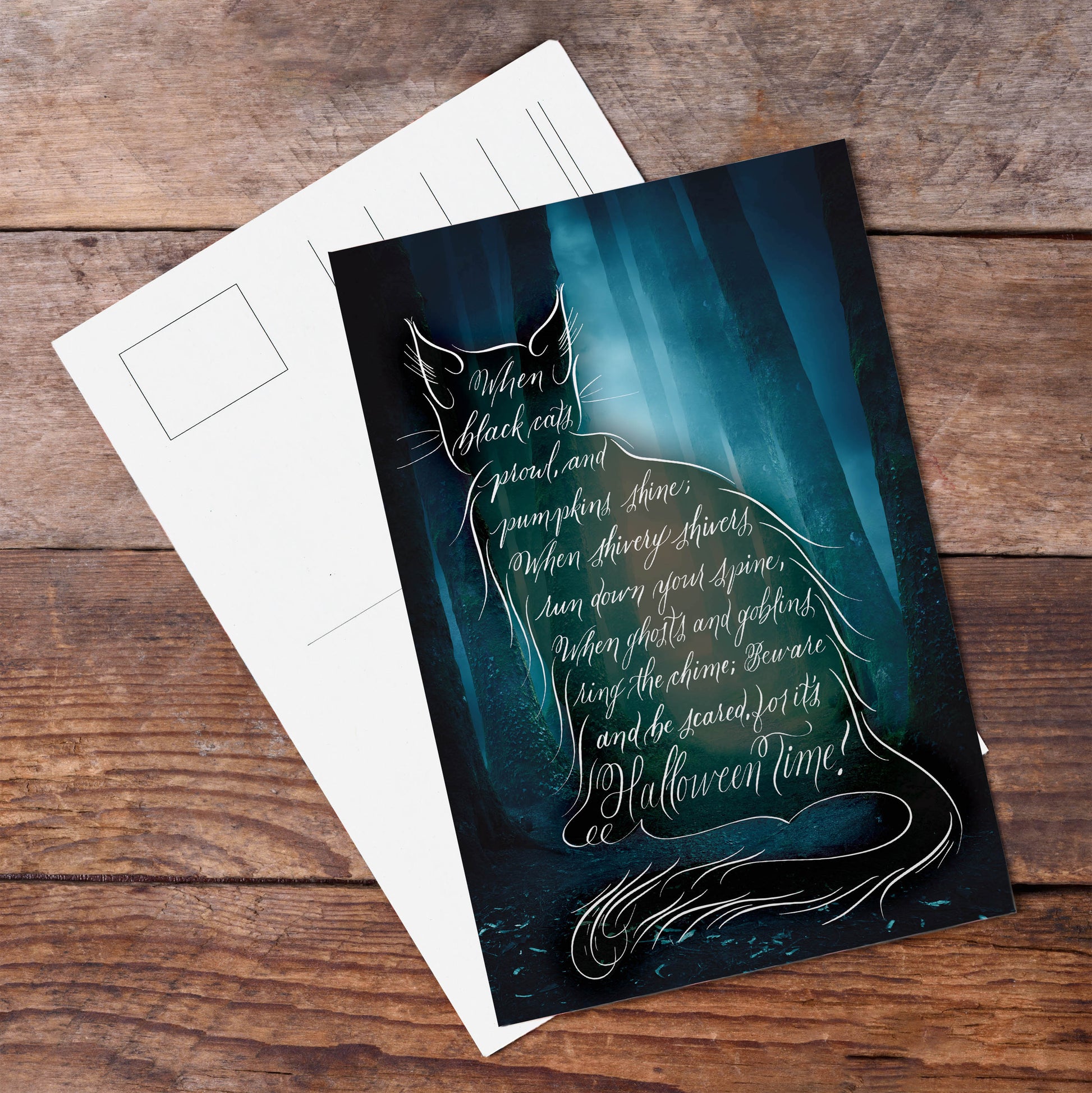 A lifestyle top view of the Halloween calligraphy postcard "Black Cat Poem"