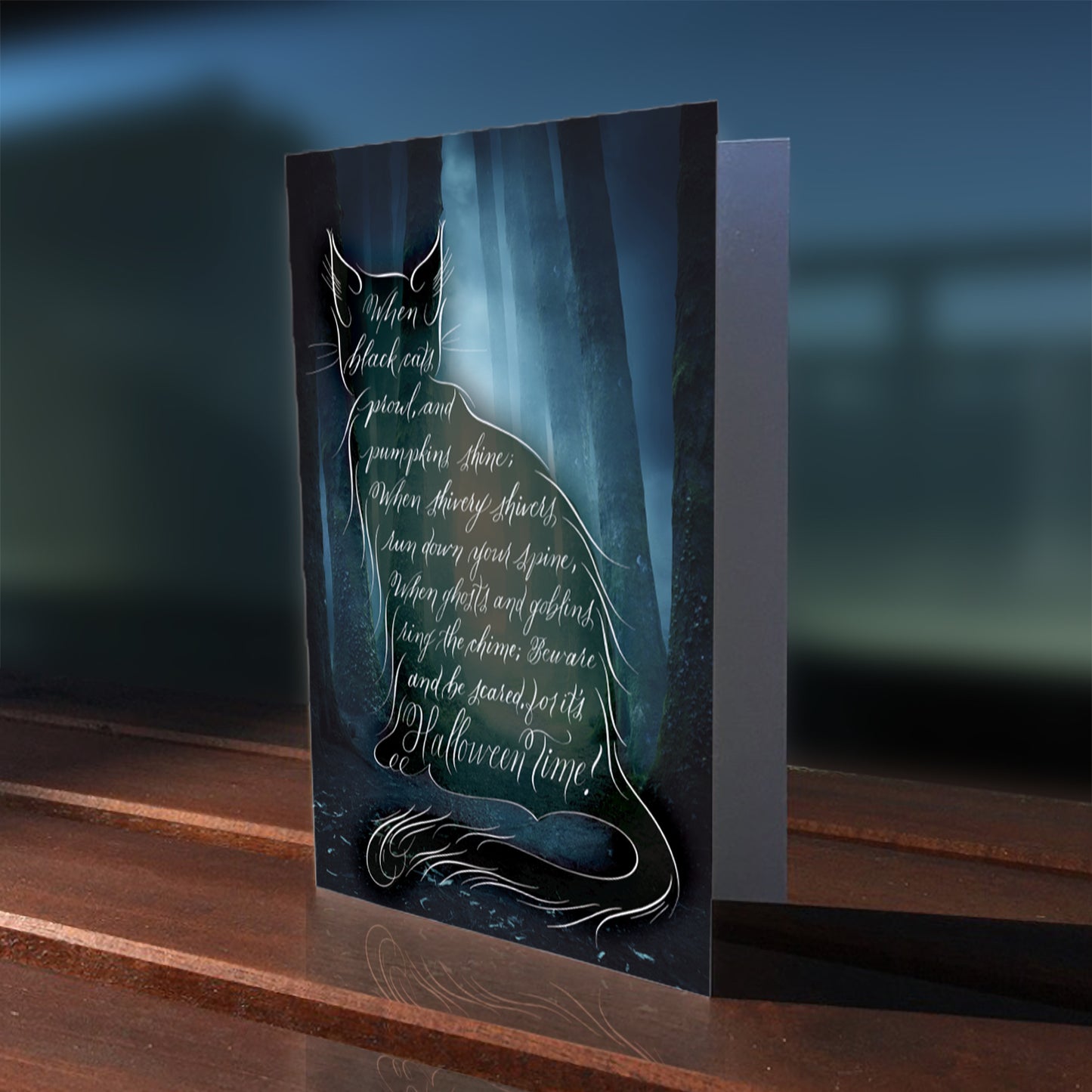 A lifestyle view of Halloween calligraphy greeting card "Black Cat Poem"