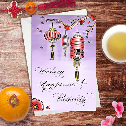 Lifestyle desk image: Wishing Happiness  and Prosperity Lunar New Year Greeting Card, designed in calligraphy with red lanterns and blossoms on a purple landscape