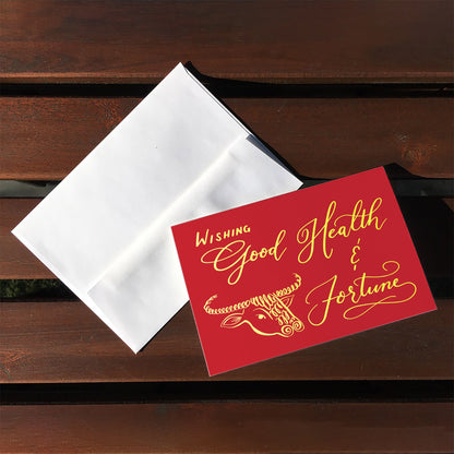 A top view of the greeting card: "Wishing Good Health & Fortune"