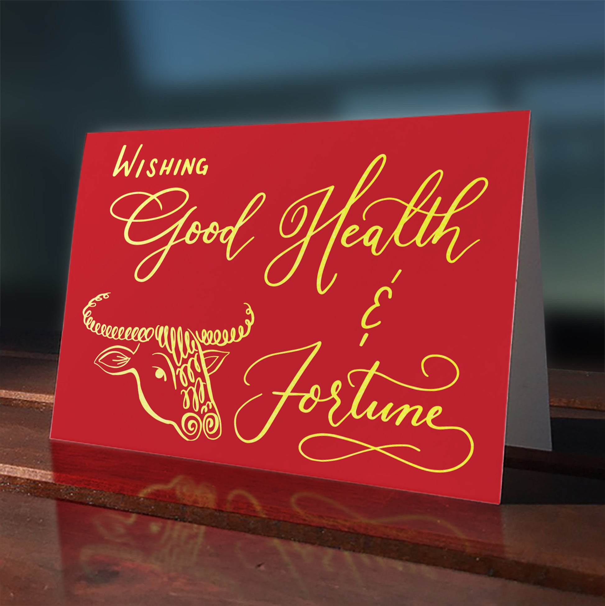 A lifestyle view of the greeting card: "Wishing Good Health & Fortune"