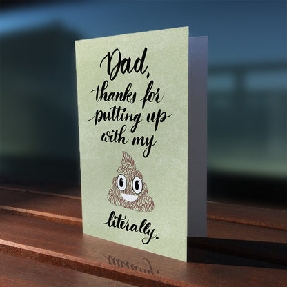 A lifestyle view of the Toronto Calligraphy greeting card: "Dad, thanks for putting up with my crap. Literally."
