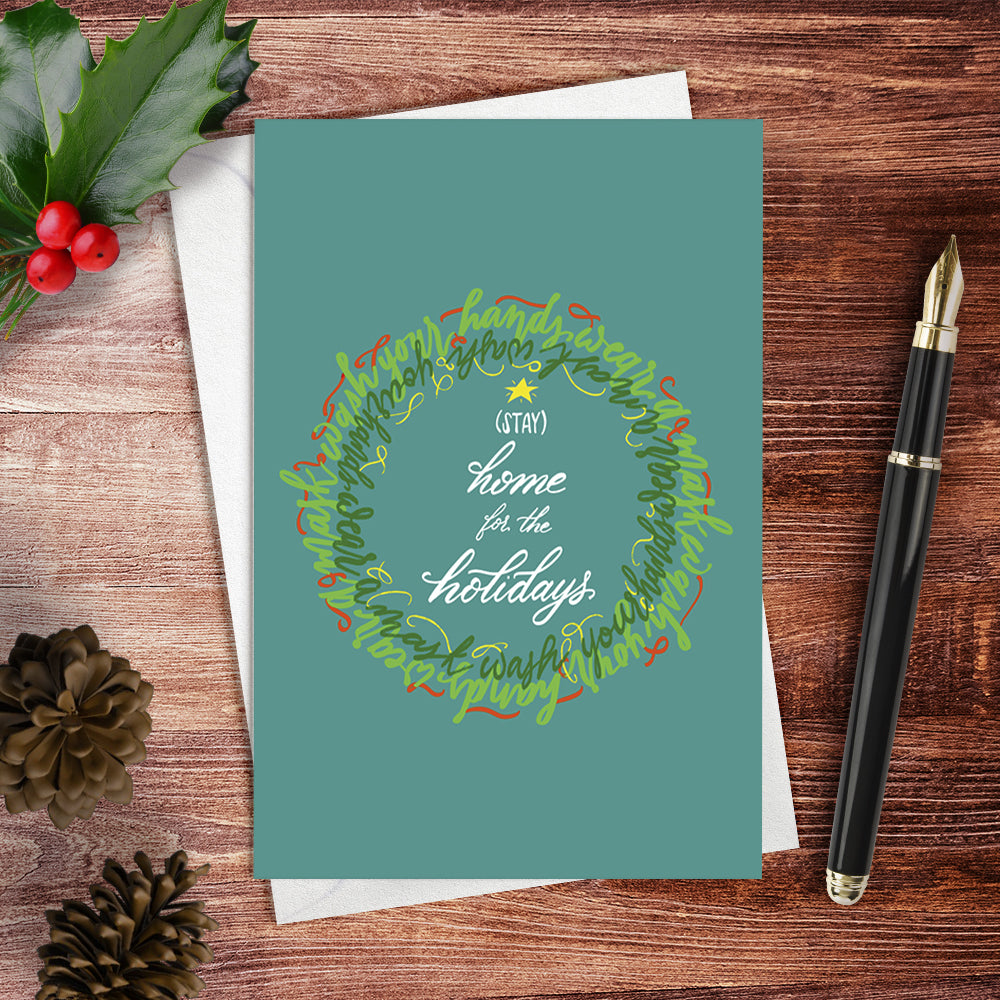Lifestyle image of the winter holiday greeting card: "Stay Home for the Holidays"